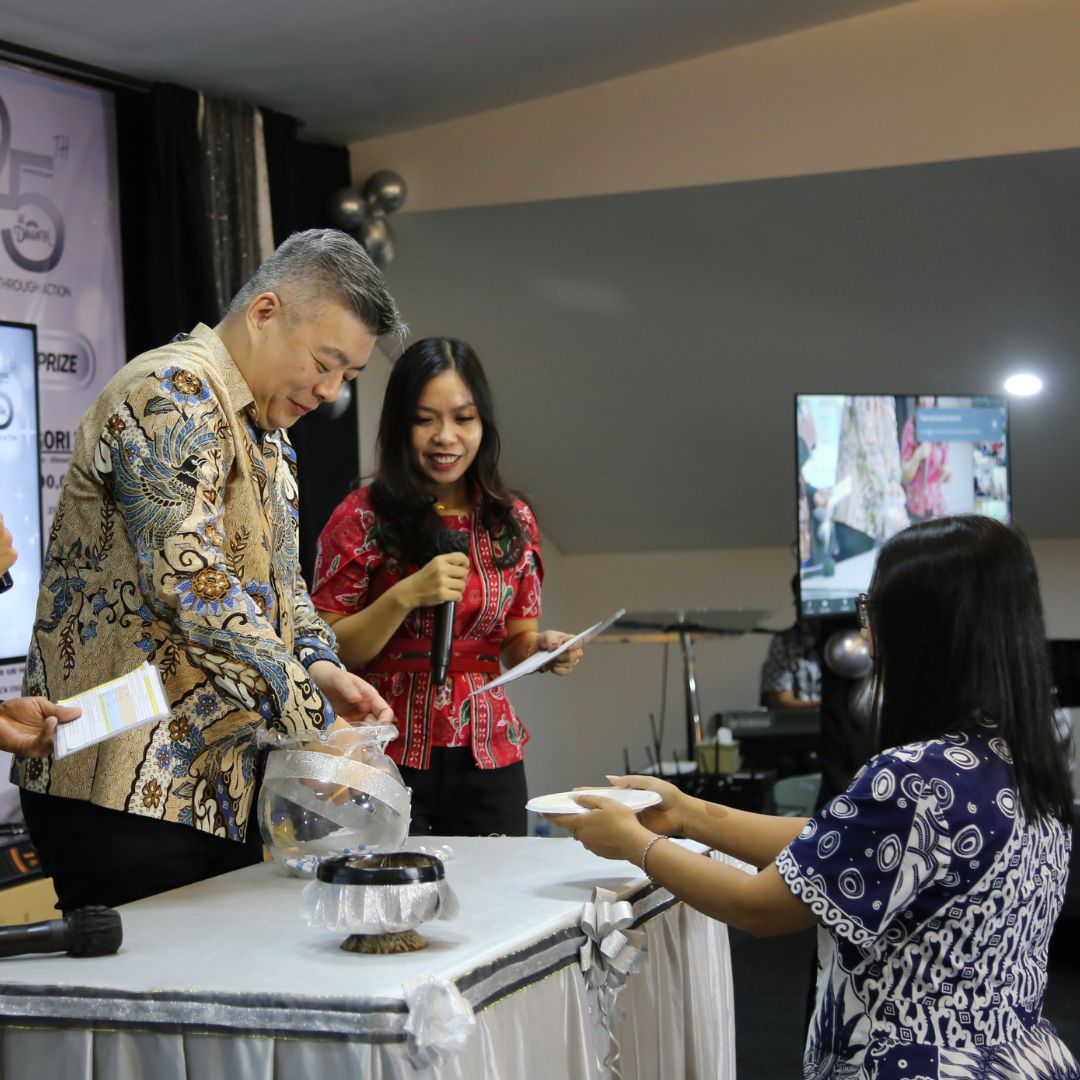 Mr. Peter taking the name for door prize at the 25th Anniversary of Dian Mandiri
